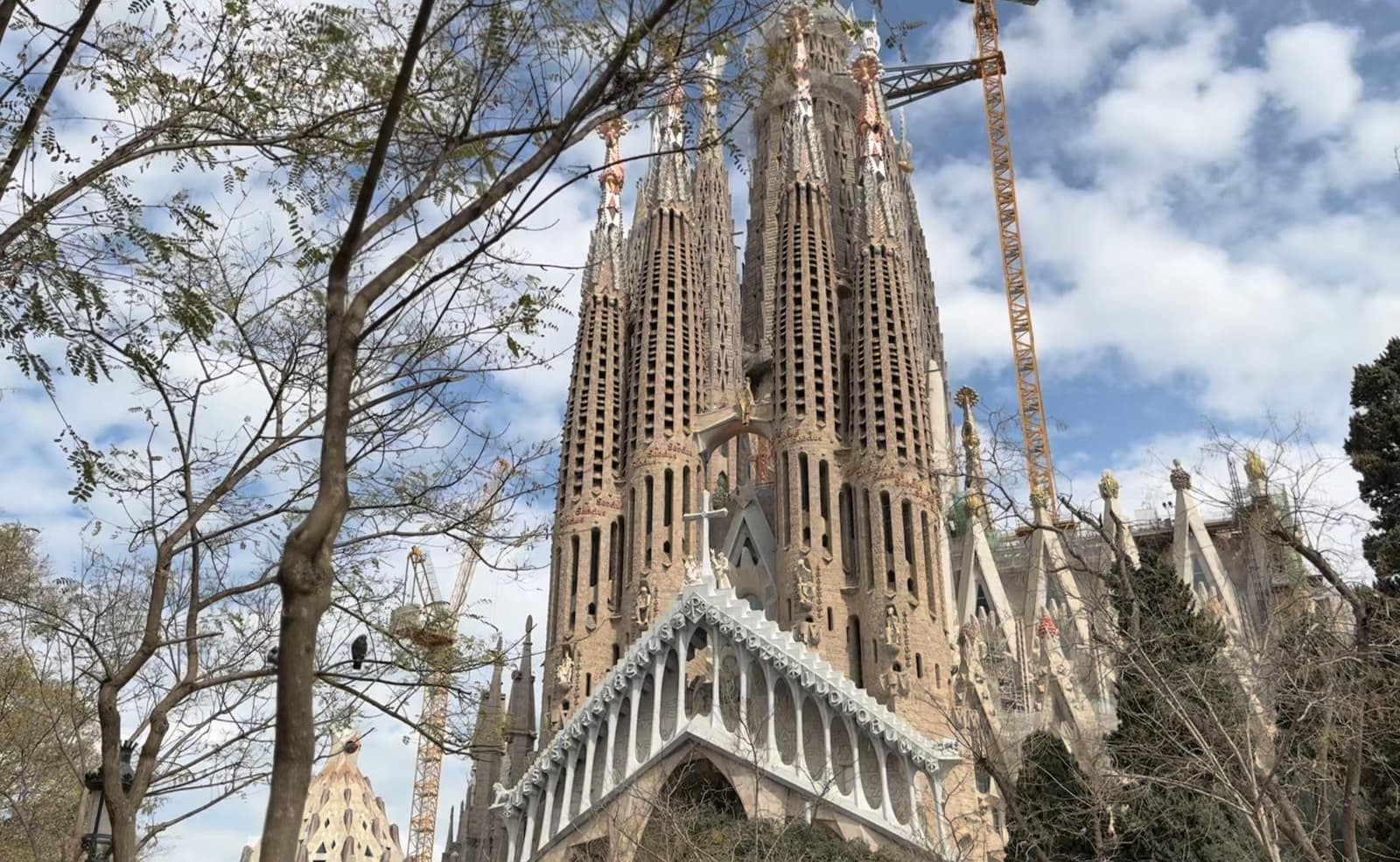 The towers and detailed stone facade of the Sagrada Família in Barcelona