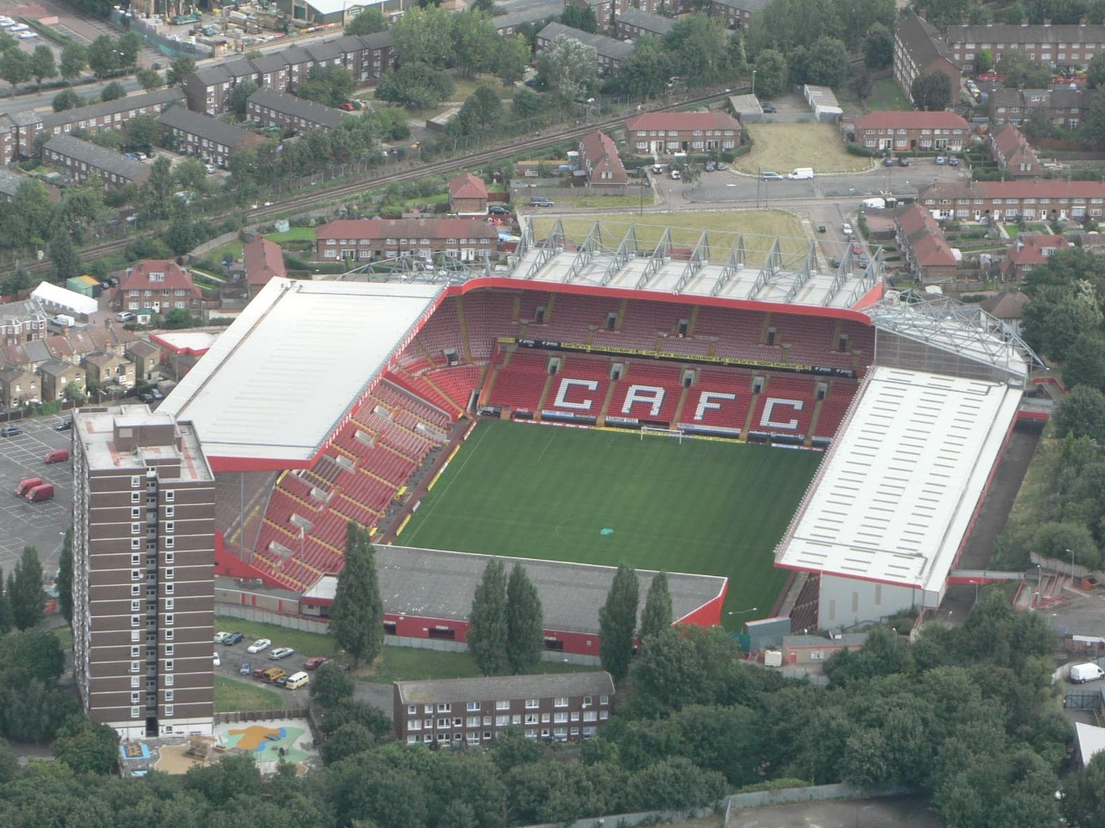 https://commons.wikimedia.org/wiki/File:Charlton_Athletic_football_ground.jpg Resized and converted to JPEG by Futbela; card and portrait derivatives cropped around an editorial focal point.